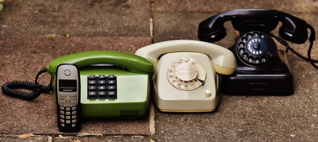 a phone and a couple of electronic devices on a table