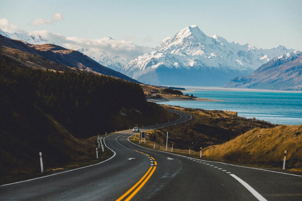 a road with a mountain in the background