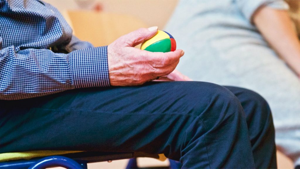 a person holding a small green object