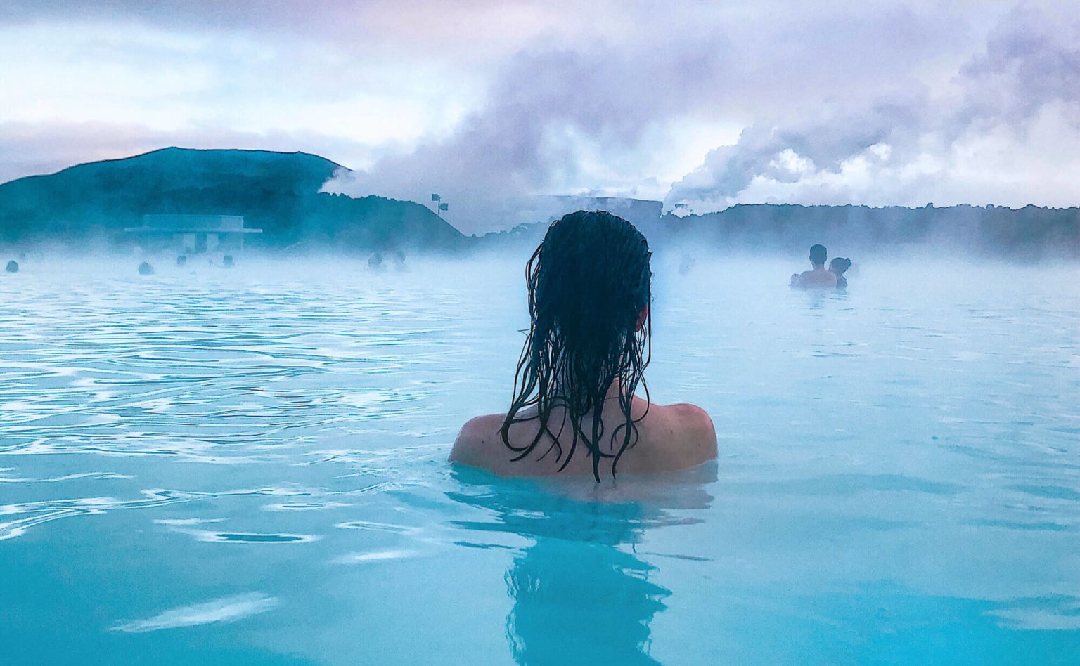a person in the ocean with Blue Lagoon in the background