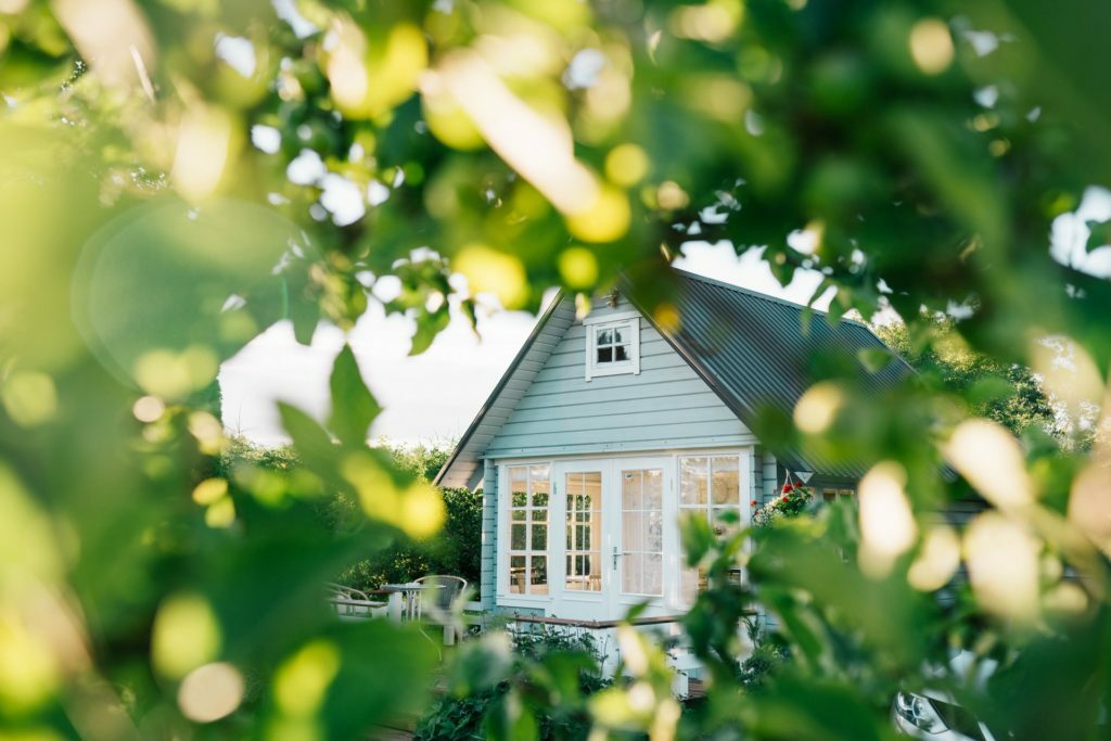 a small house with a tree in the background