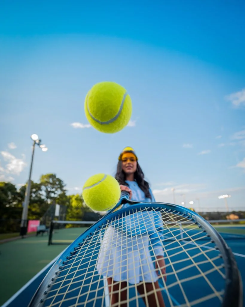 a person standing next to a net with a ball on it