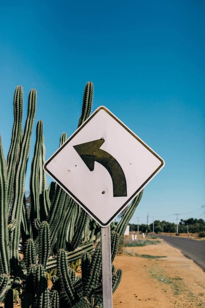 a sign with a triangle and arrow