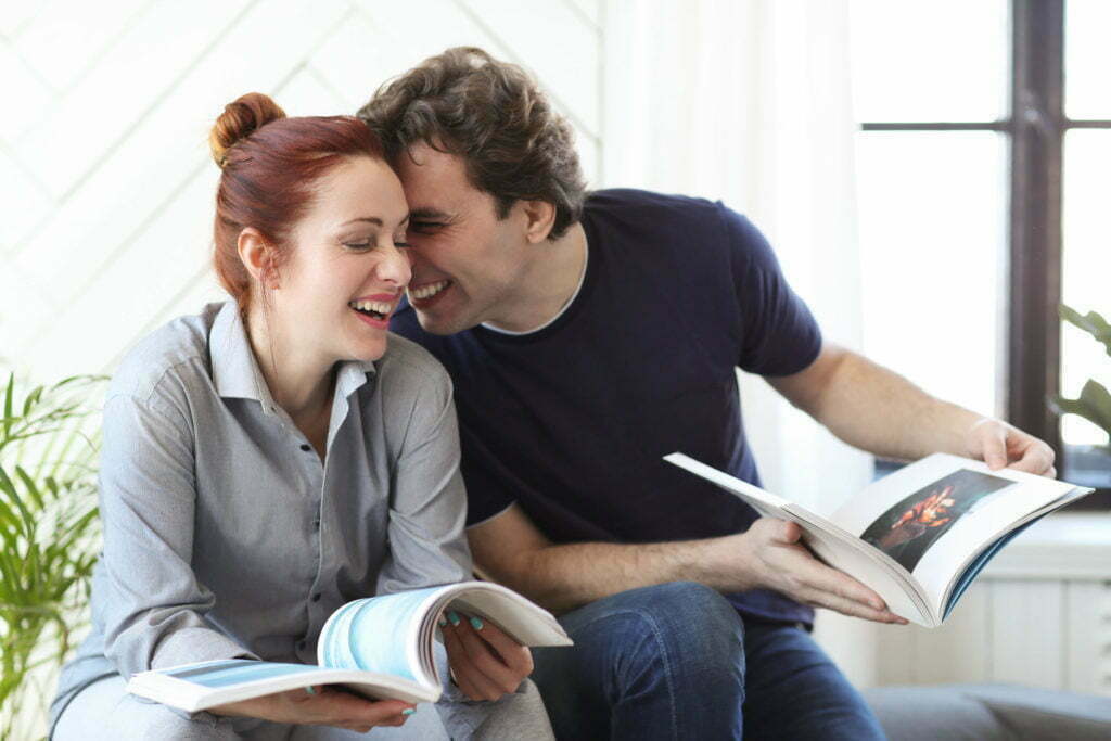 a woman and a man looking at a piece of paper