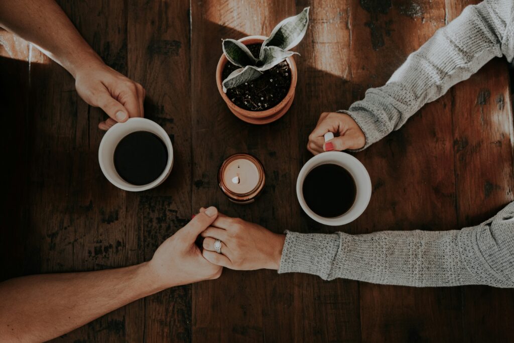 a group of people holding cups of coffee