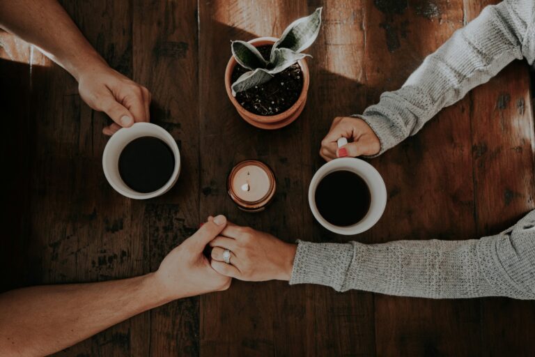 a group of people holding cups of coffee